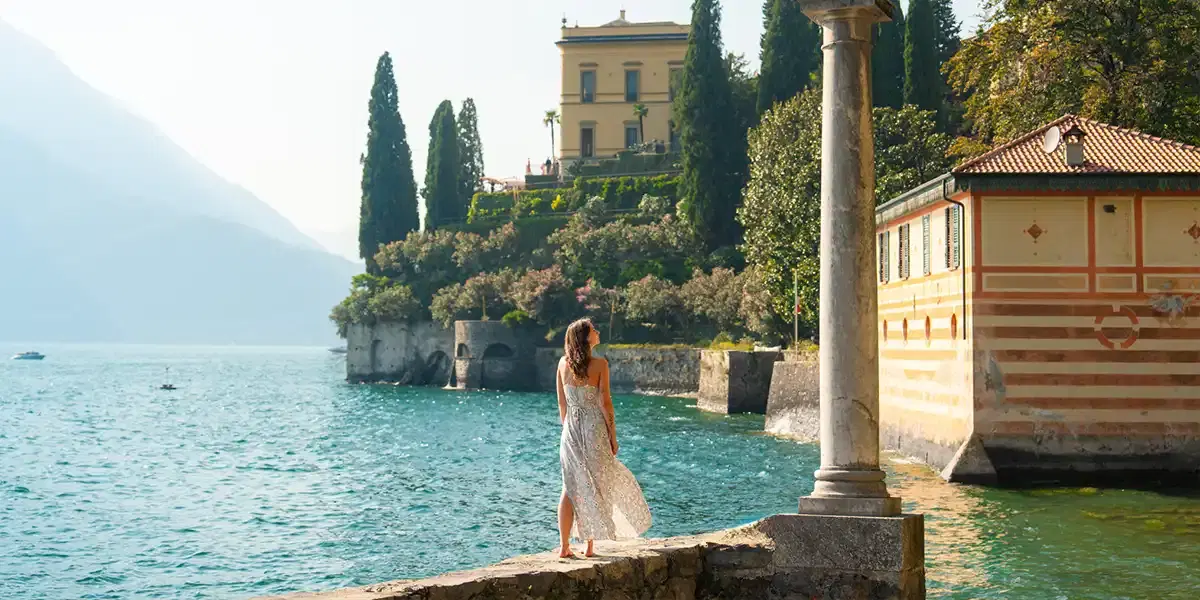 Woman enjoying the lakeside views near a historic villa on Lake Como