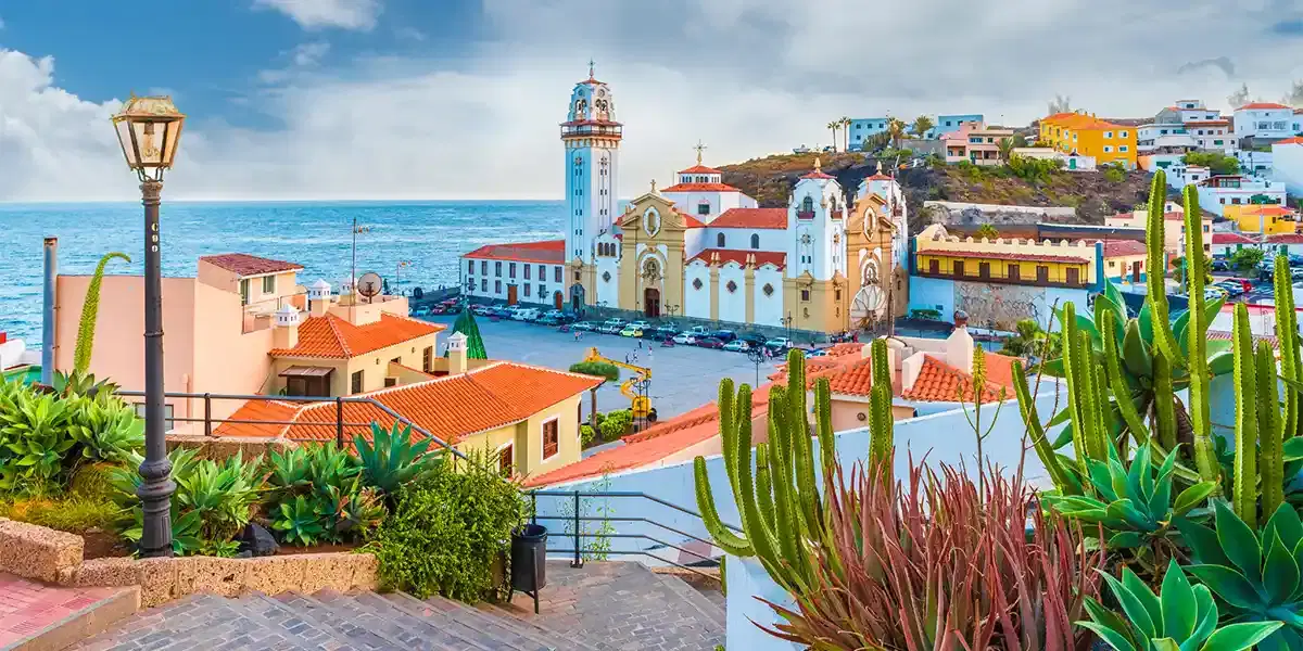 Colourful hilltop town of Candelaria in Tenerife with whitewashed basilica, terracotta rooftops and Atlantic Ocean views